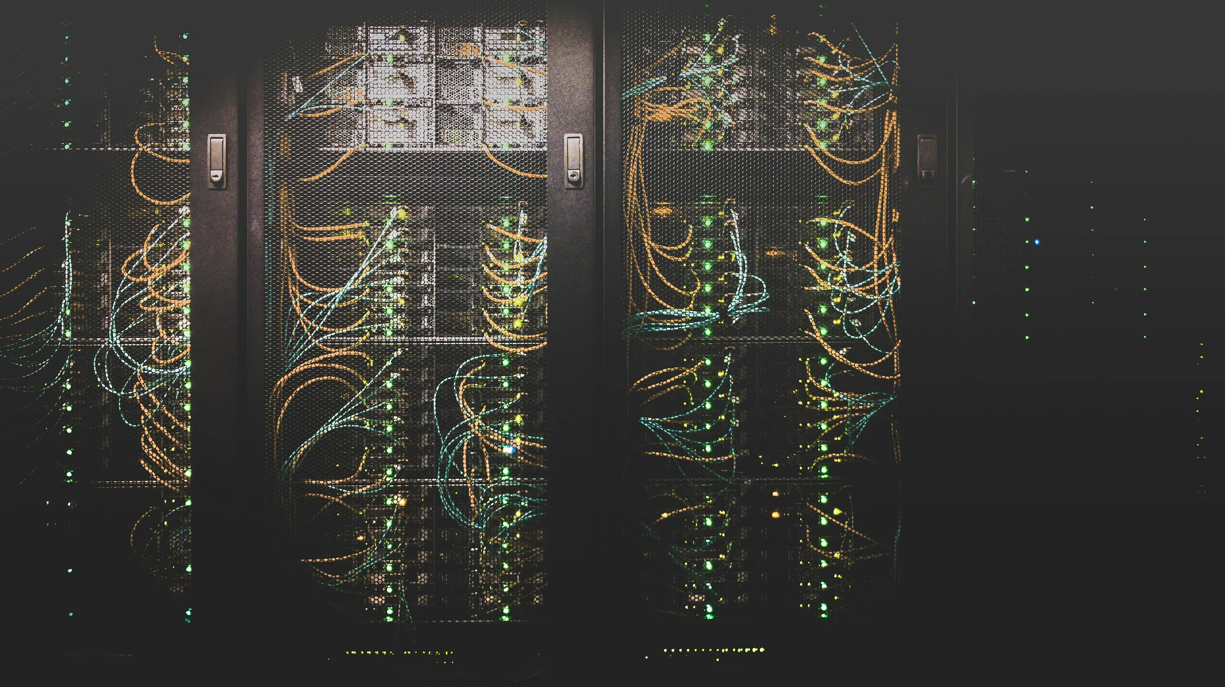Floor-standing network cabinet glowing with active patch leads