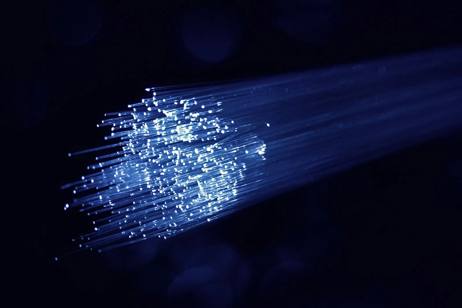 Lit fibre optic cable showing data flowing through the strands